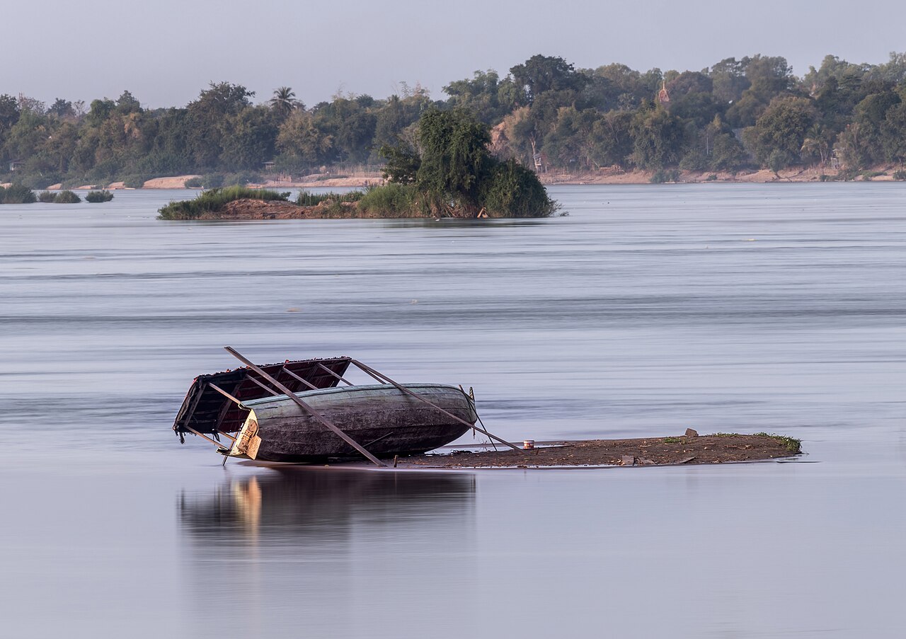 Careening of a pirogue on a sandy beach of a tiny
